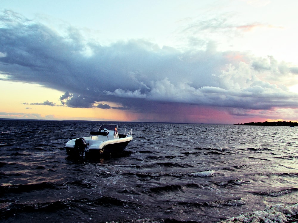 Dark Evening Blue Cloudy Alone Boat In Ocean Wallpapers