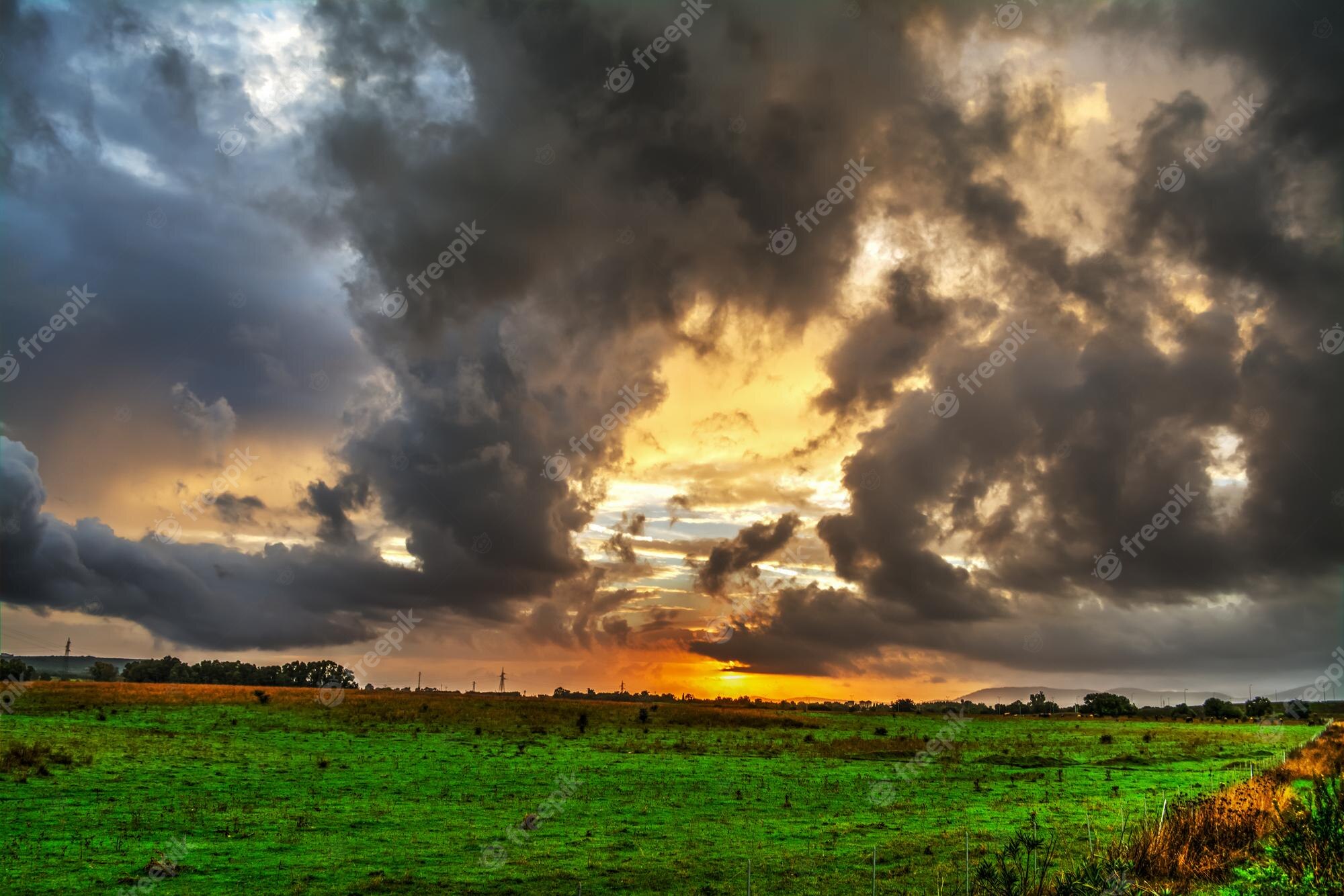 Dramatic Field Under Dark Clouds Wallpapers