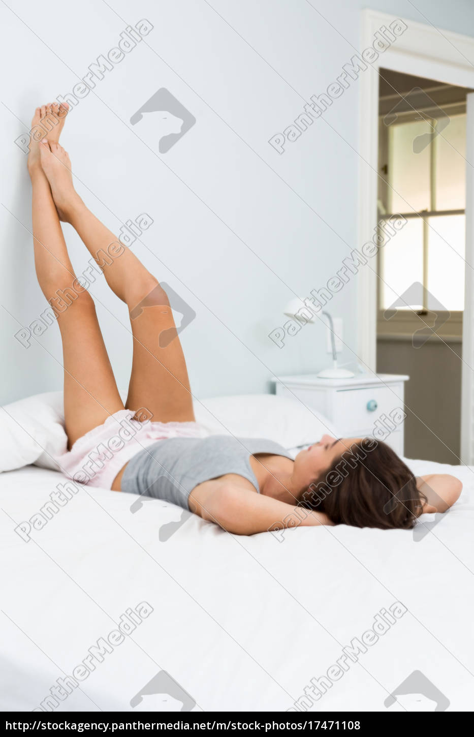 Girl Lying On Bed Legs Up Wallpapers