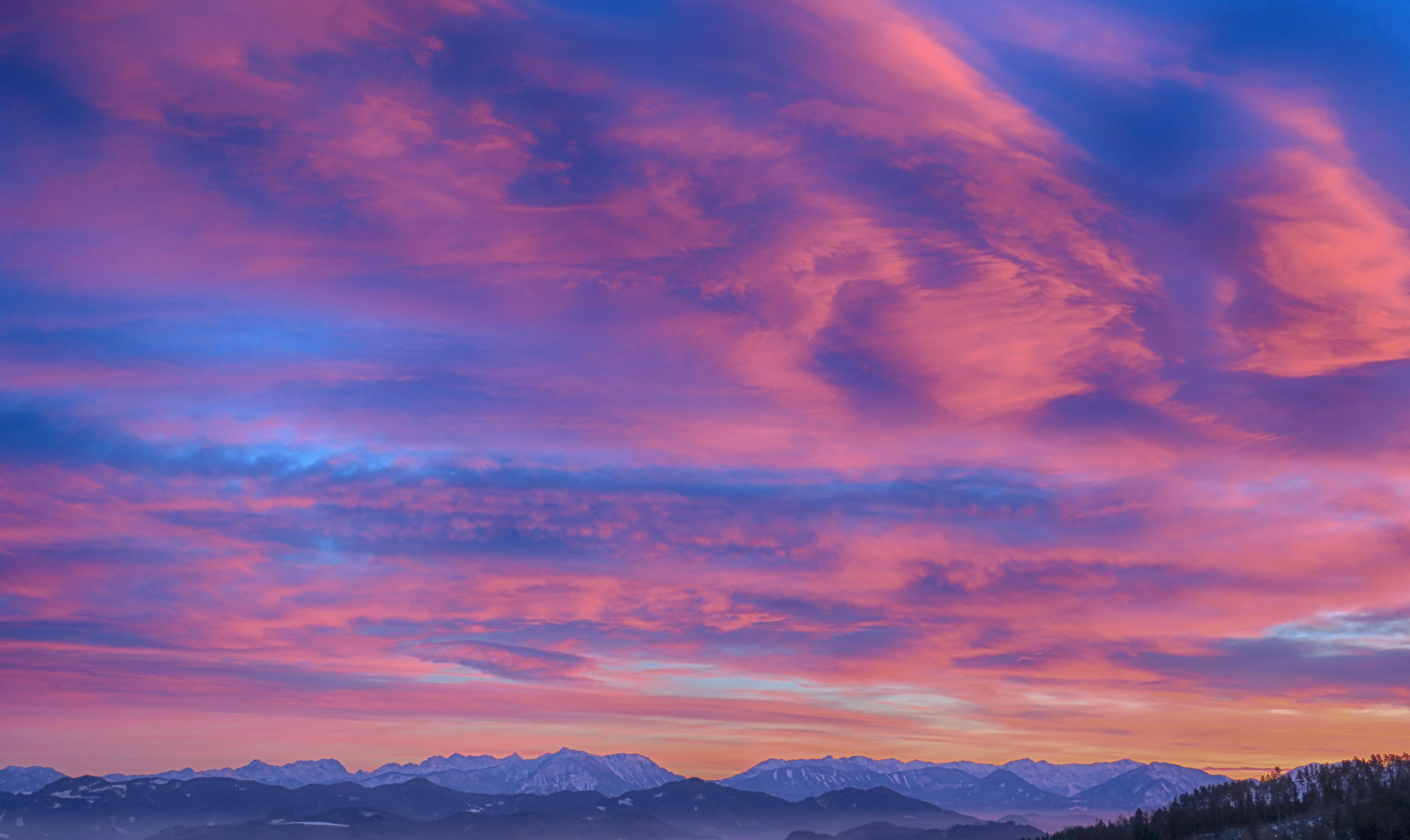 Mountain With Clouds In Background Of Blue And Purple Sky