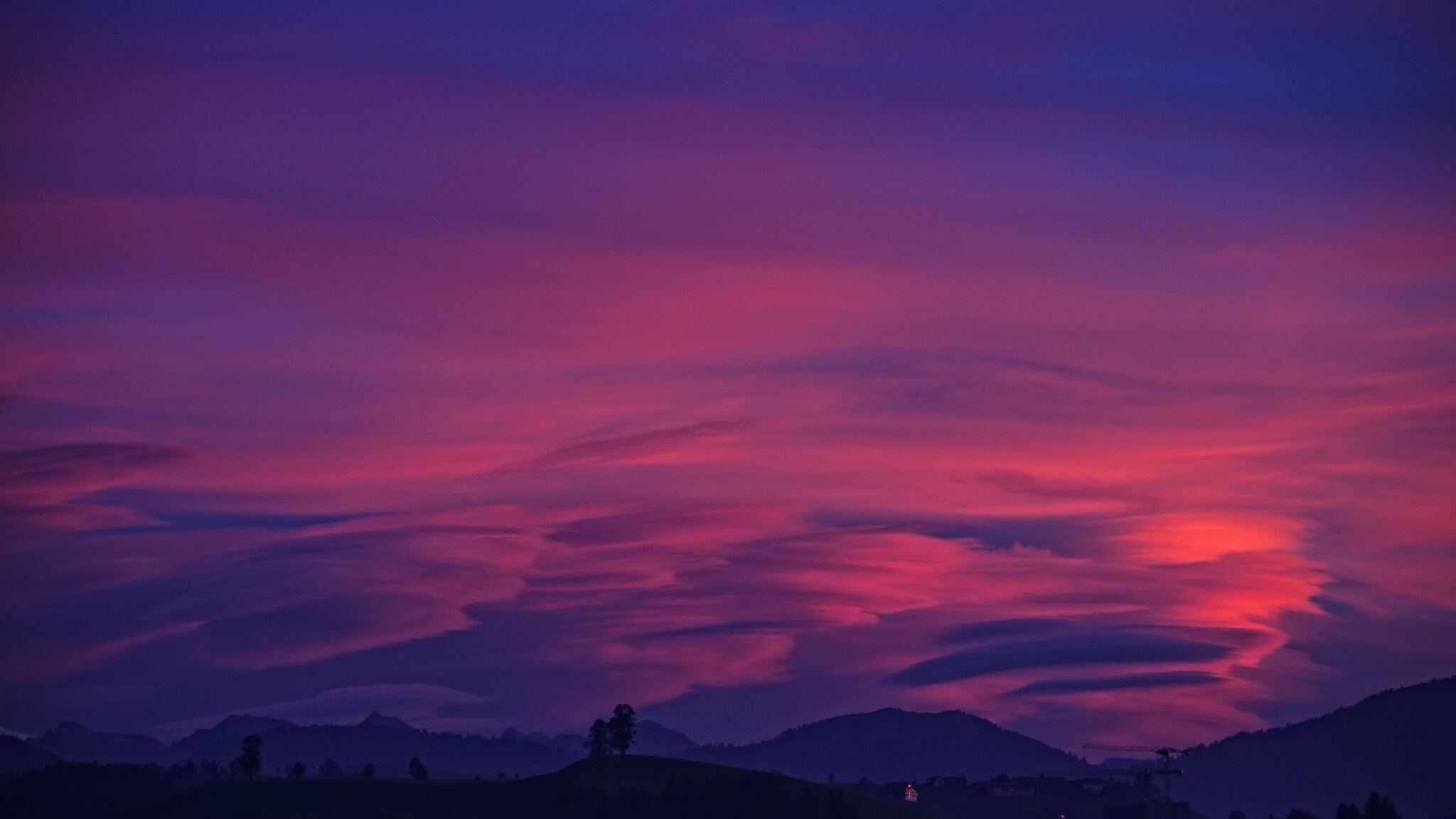 Mountain With Clouds In Background Of Blue And Purple Sky