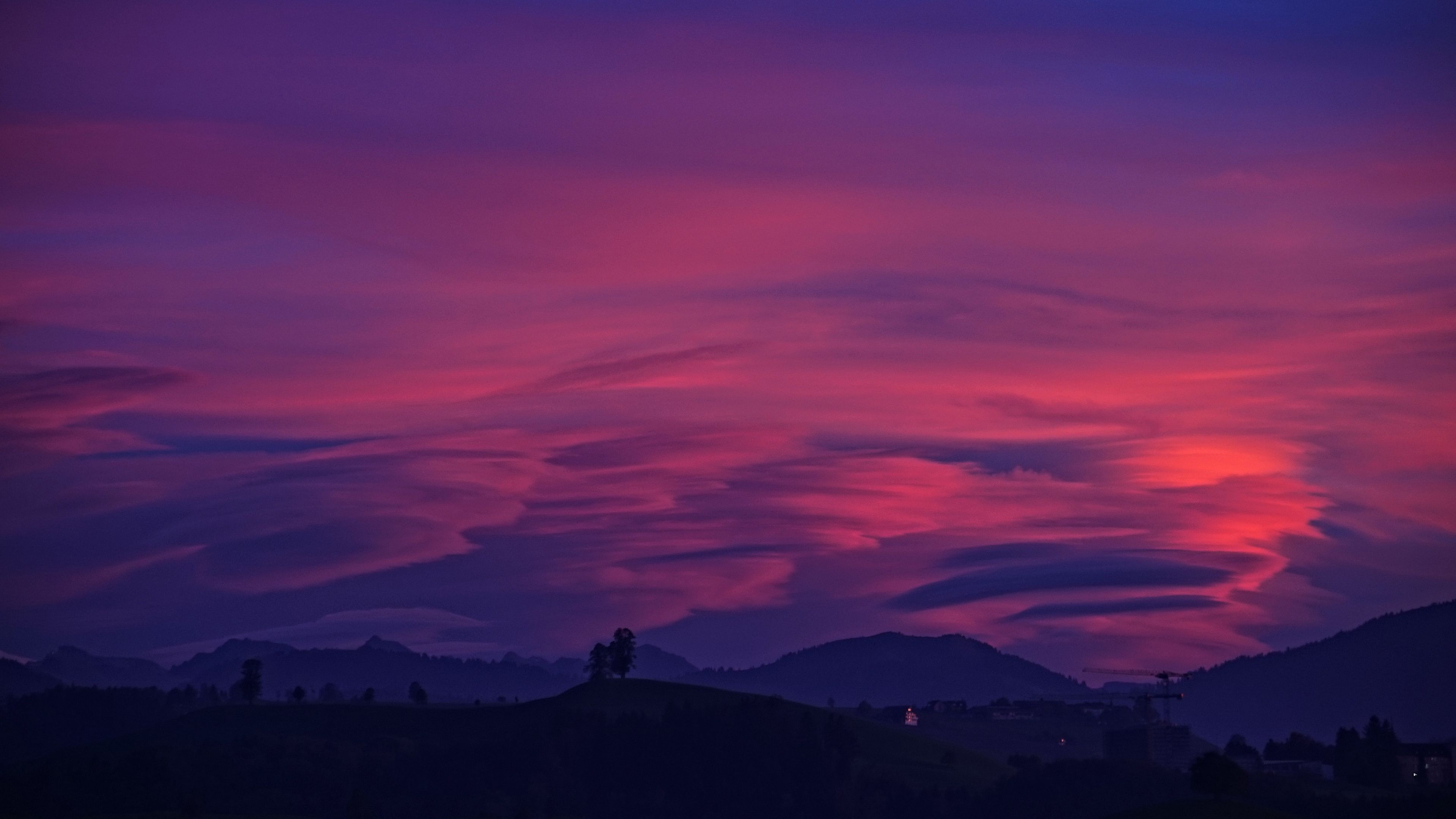 Mountain With Clouds In Background Of Blue And Purple Sky