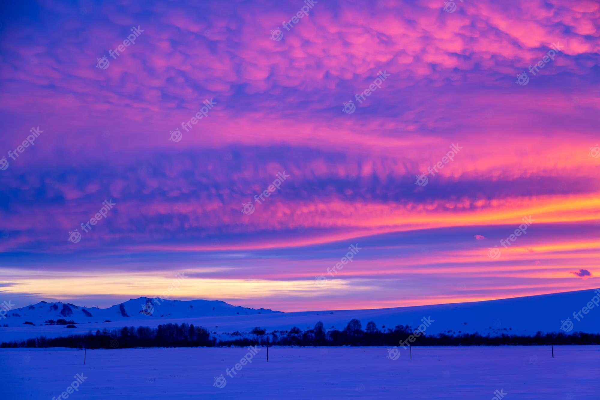 Mountain With Clouds In Background Of Blue And Purple Sky