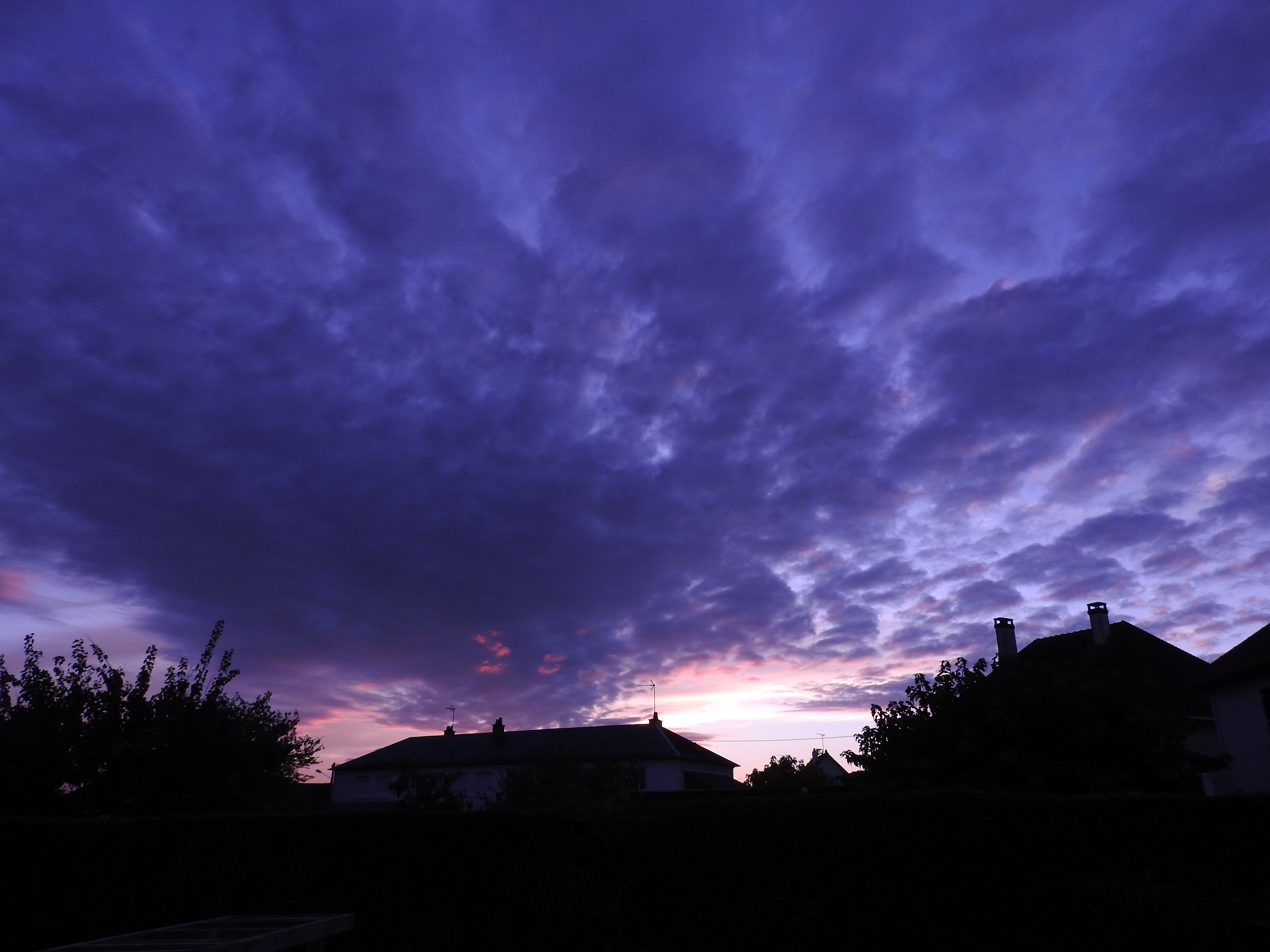 Mountain With Clouds In Background Of Blue And Purple Sky