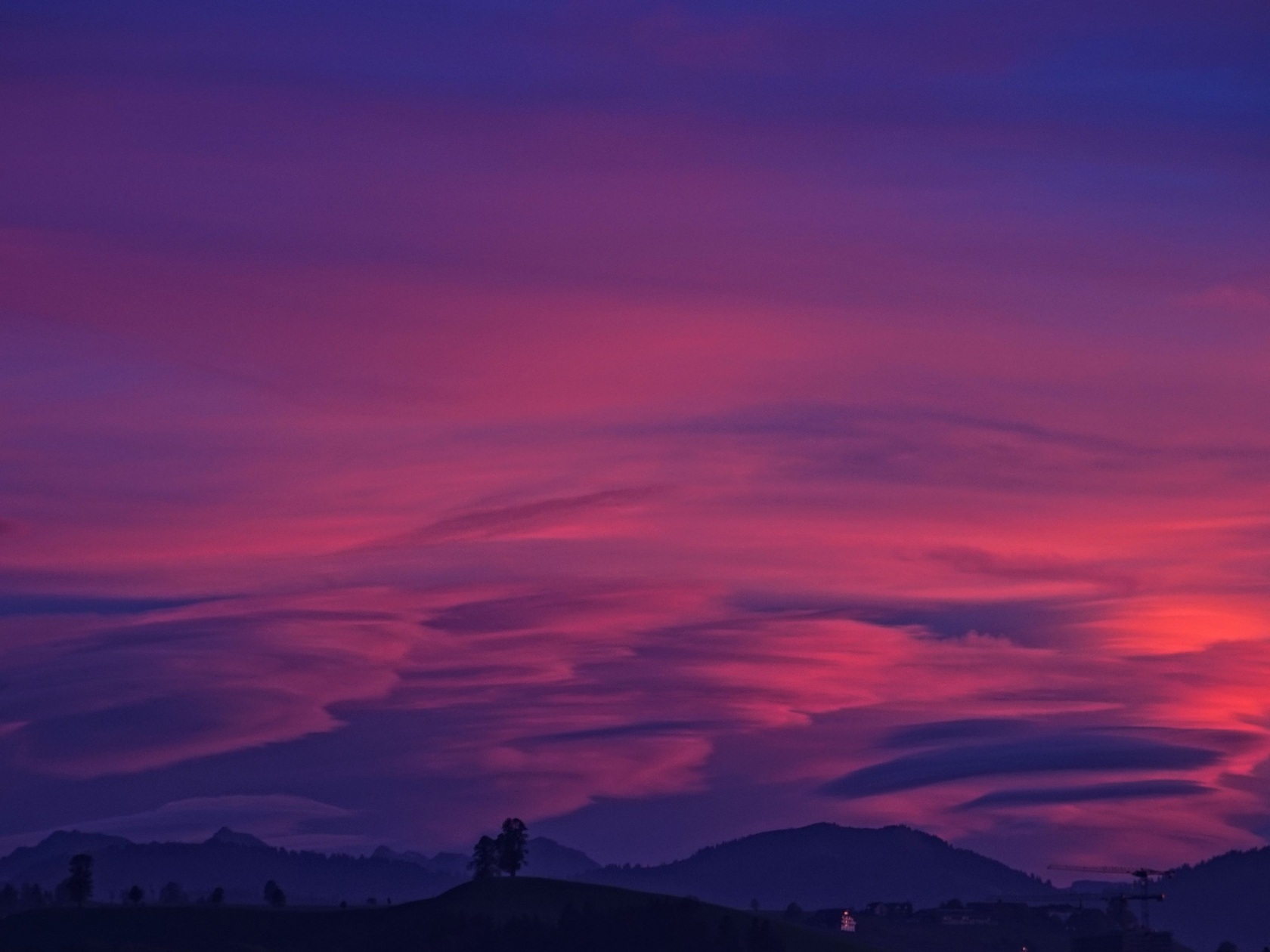 Mountain With Clouds In Background Of Blue And Purple Sky