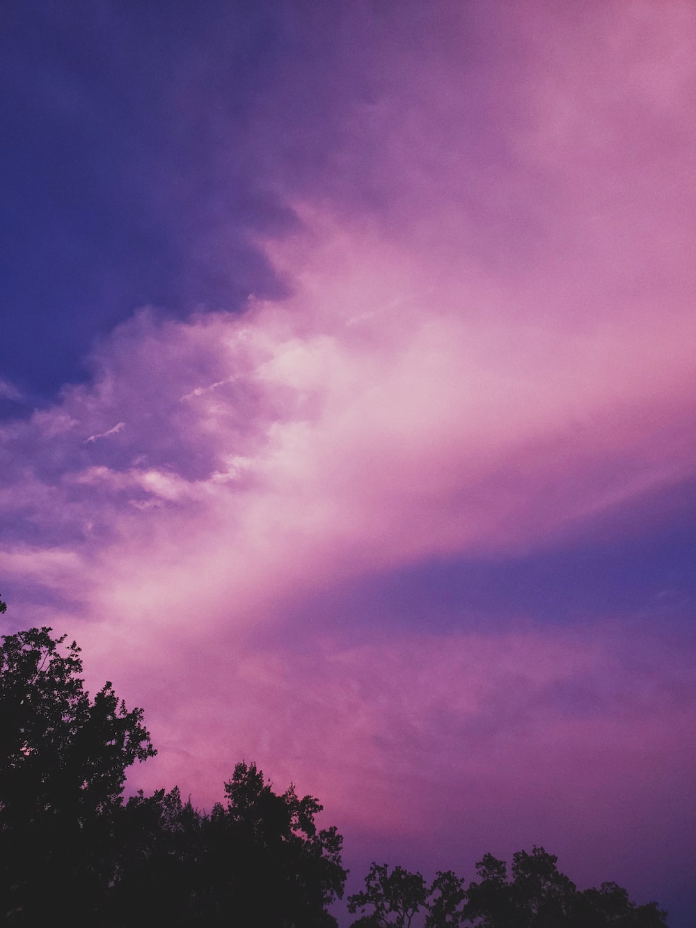 Mountain With Clouds In Background Of Blue And Purple Sky