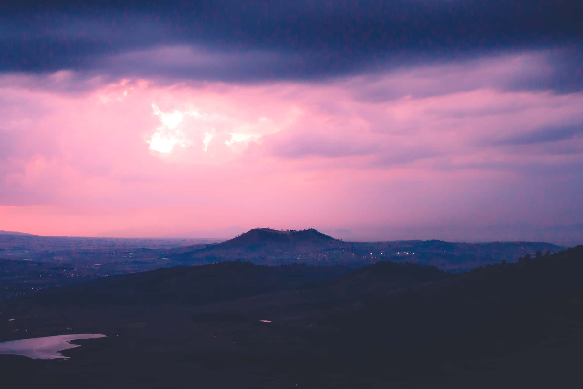 Mountain With Clouds In Background Of Blue And Purple Sky