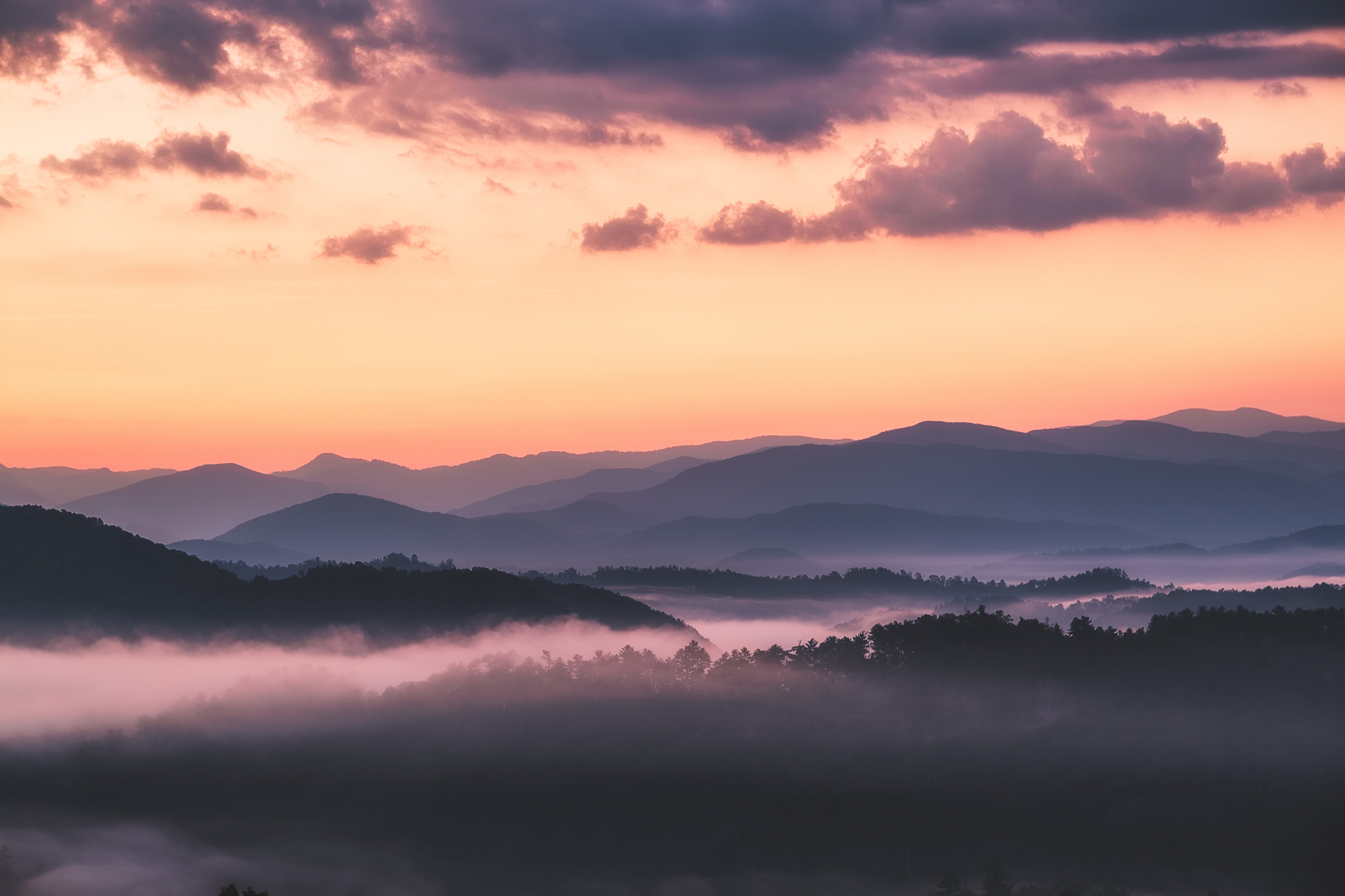 Mountain With Clouds In Background Of Blue And Purple Sky