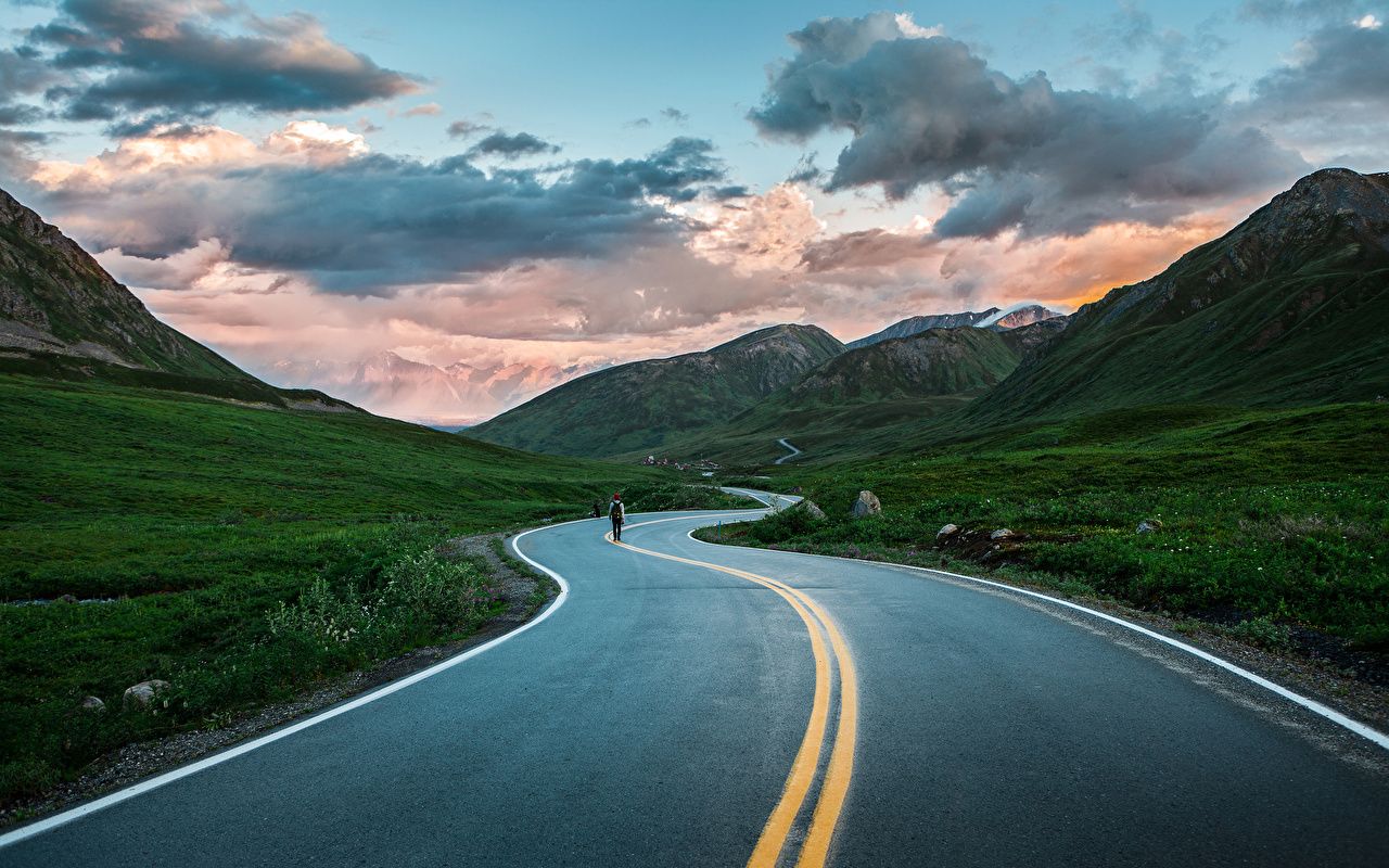 Road With Background Of Mountains And Clouds