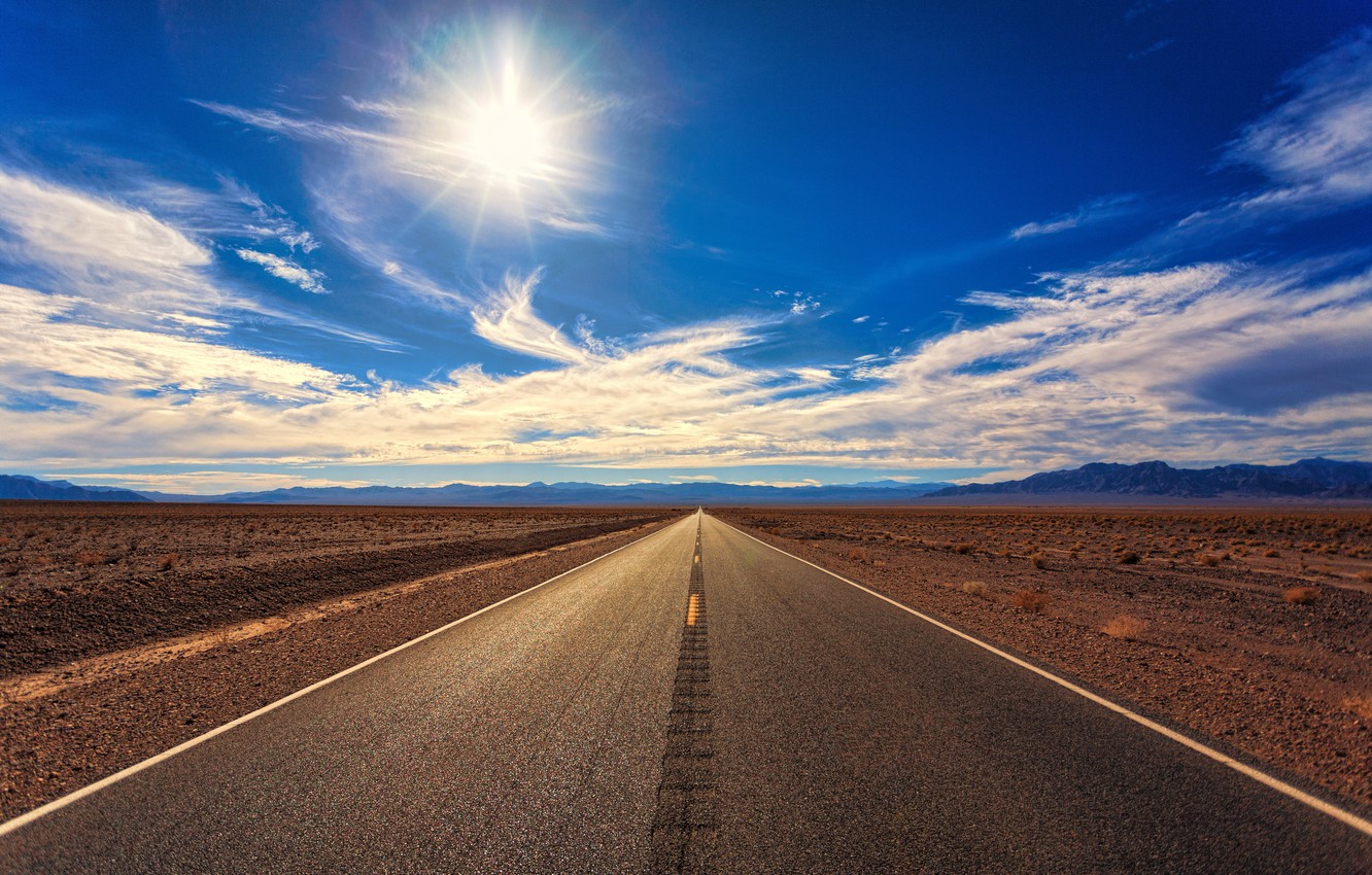 Road With Background Of Mountains And Clouds