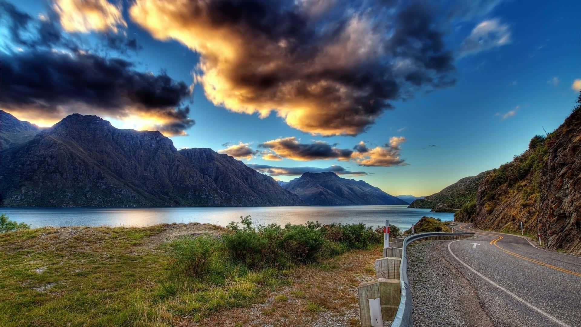 Road With Background Of Mountains And Clouds