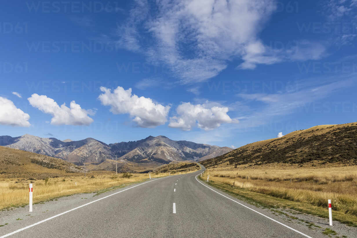 Road With Background Of Mountains And Clouds