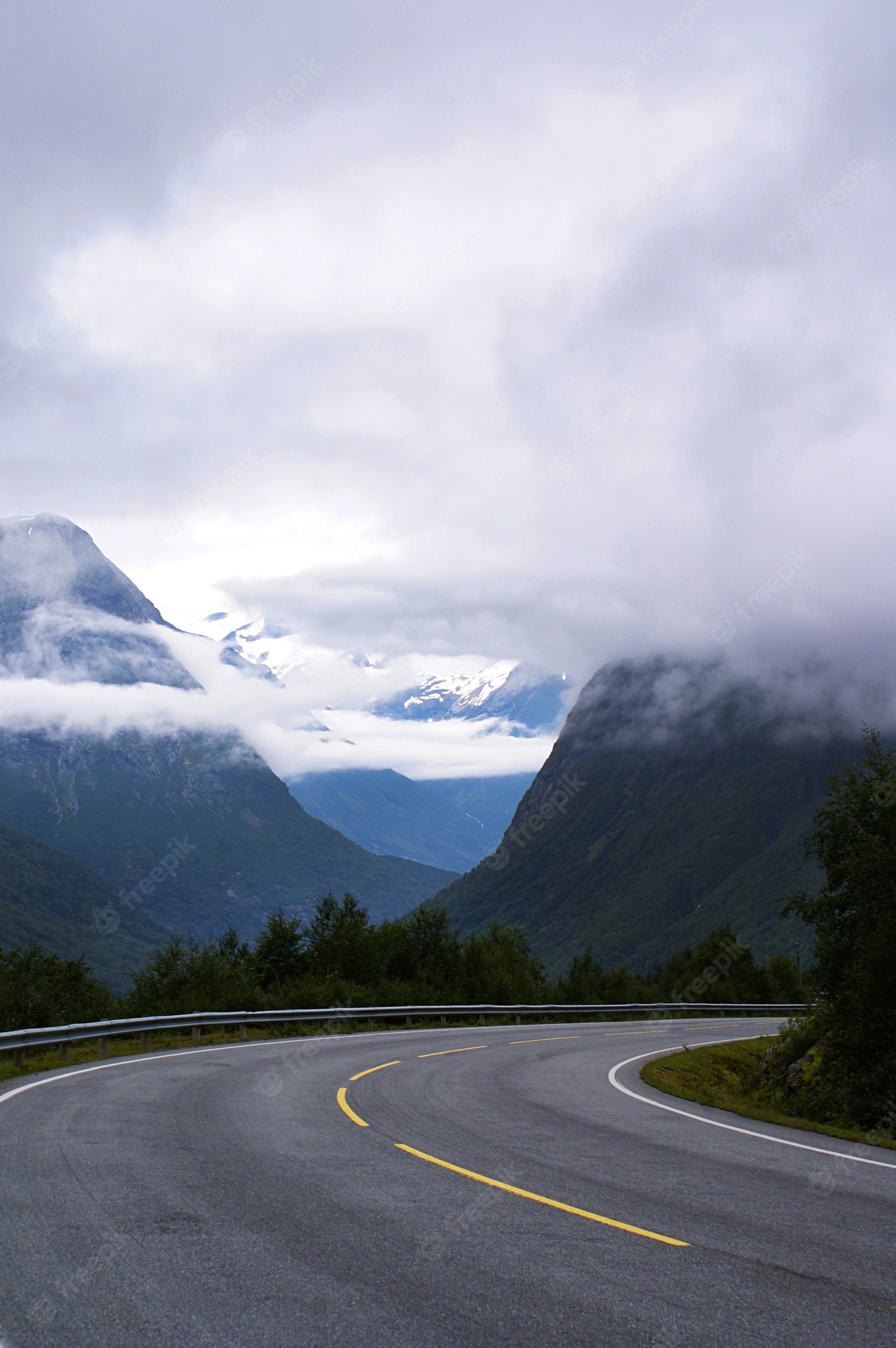 Road With Background Of Mountains And Clouds