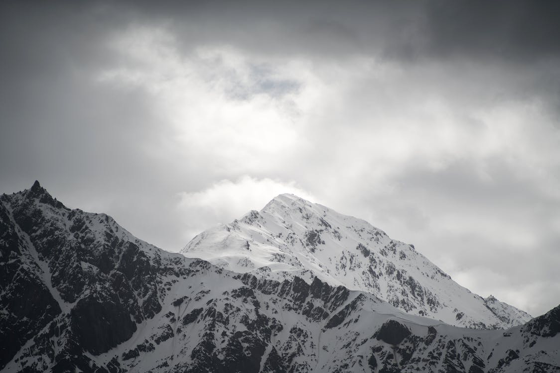 Snow Covered Mountains Under Black Cloudy Sky Wallpapers